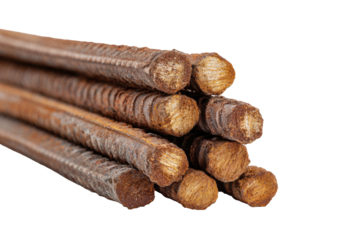 Stack of rusty, grooved steel rebar rods, cut ends exposed on dark background