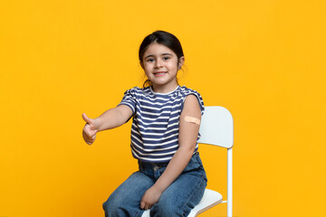 Kids Vaccination. Vaccinated Little Arab Girl Gesturing Thumb Up After Covid-19 Vaccine Injection,...