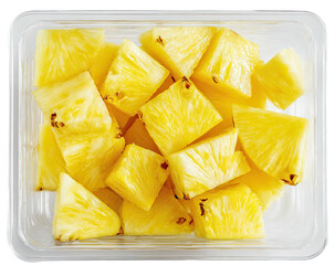 Diced pineapple pieces filling a clear plastic container