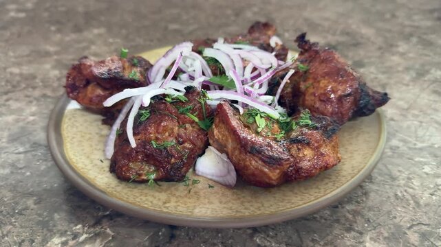 crispy grilled chicken wings on plate, topped with thinly sliced red onion and parsley, charred edges glazed with smoky marinade, rustic stone surface, closeup foodporn shot