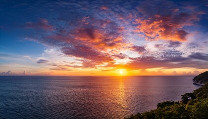 Obraz premium Majestic Sunset Over A Tranquil Ocean Featuring A Vibrant And Dramatic Cloudscape Painting The Sky With Brilliant Orange Yellow And Pink Hues A Serene Natural Landscape At Dusk