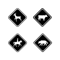 Obraz premium Set of four diamond-shaped warning signs with animal silhouettes.