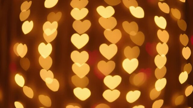 Heart bokeh warm light string blurred background golden glow heart shaped romantic festive abstract night soft focus pattern decorative celebration holiday illumination out of focus romantic gold