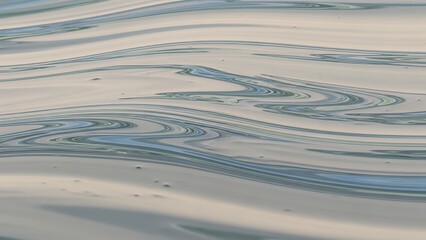 A serene abstract pattern of smooth ripples on a calm surface viewed from above