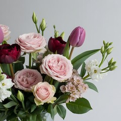 Beautiful floral arrangement with pink roses, purple tulips, and white accents