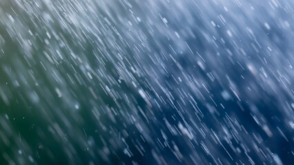 Abstract soft particles falling in a blurred motion against a dark blue background