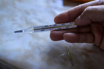 a thermometer in a person's hand