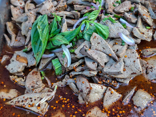 Pork liver is seasoned with a spicy chili powder that appears to contain Thai herbs.