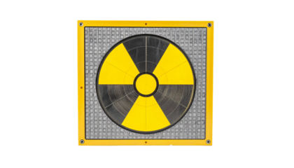 A yellow and black hazard symbol on a metallic, square surface