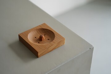 Modern wooden ashtray on a white surface