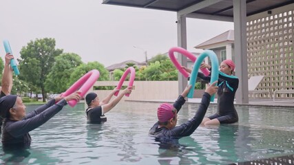 Group Asian Geriatric exercise before Aquatic therapy in swimming pools or hydrotherapy pools by coach Physiotherapist.Elderly hydrotherapy,physiological wellness,Balance training,health care concept