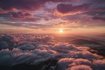 Majestic sunset illuminates layered clouds above rolling mountains, creating a vibrant panorama