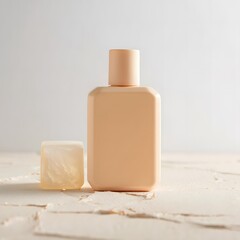 Peach colored cosmetic bottle and bar of soap on a white surface
