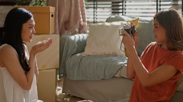 LGBT Lesbian asian couple love moments happiness concept.two lesbian girls having fun while moving and decorating into a new home or apartment.Enjoy asian lgbt couple woman move into new house