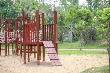 Outdoor wood playground on sand green garden background