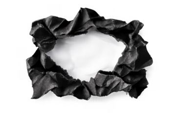 Torn black paper creating a rough hole framing a white space, revealing new ideas and discoveries