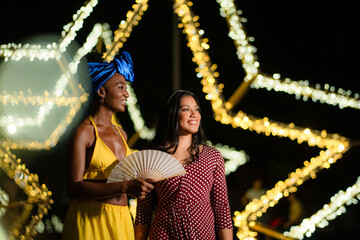 Diverse women friends enjoying nightlife celebration together