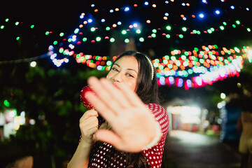Young woman enjoying candy apple during night event