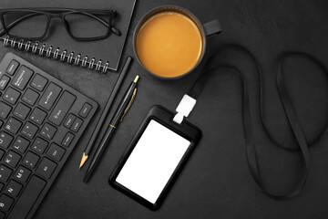 Black plastic badge with keyboard and coffee on black leather texture background. Template designed for employees of company
