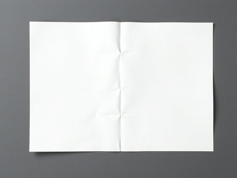 Crinkled white paper folded in half on a dark gray background