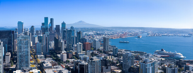 Panoramic Seattle financial district skyline in city downtown with Mount Rainier in the background.