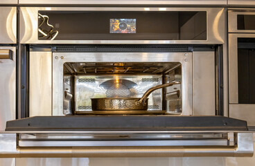 Modern kitchenware and microwave in luxury designer kitchen. Food preparation with expensive kitchen tools.