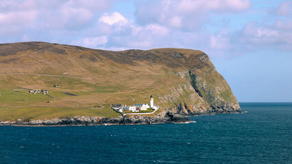 Scotland Shetland scenery in England with cliffs, ocean views and green pastures.