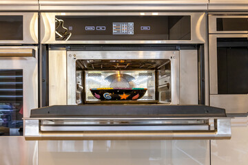 Modern kitchenware and microwave in luxury designer kitchen. Food preparation with expensive kitchen tools.