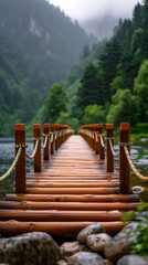 Wooden bridge extending over tranquil lake with misty mountains