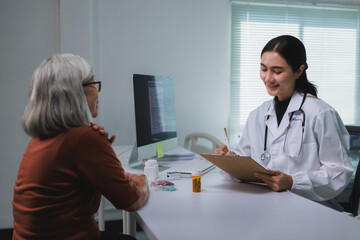 Female doctor consulting senior woman patient about health