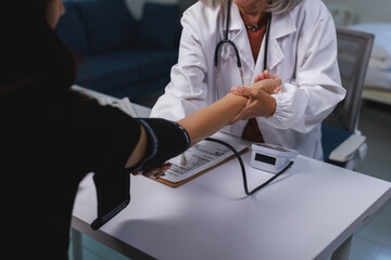Doctor checking patient pulse during health examination
