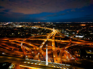 Aerial night view of Turcot Interchange in Montreal with glowing highways and city lights at dramatic blue hour. g. © Artem Onoprienko