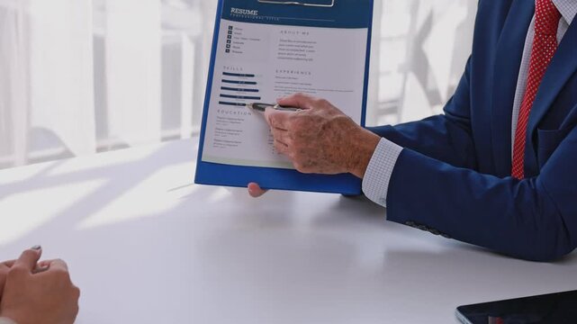 Hiring manager interviewing candidate discussing resume