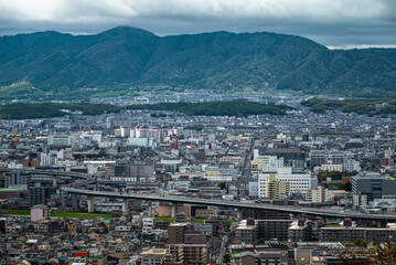 View of Kyoto&rsquo;s suburban skyline with mountains in the background.