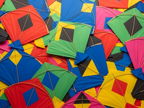 A vibrant array of colorful indian patang kites piled together for the kite festival