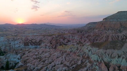 Goreme, Nevsehir, Turkey. Beautiful sunset over Red Valley in Cappadocia with vibrant red and gold rock formations.. Aerial View