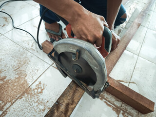 Wood Cutting Process Using Electric Handheld Circular Saw by Carpenter in Carpentry and Construction Work
