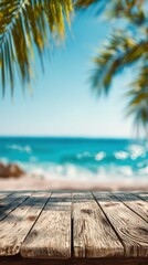 Fototapeta premium A serene beach view with wooden planks in the foreground, framed by palm leaves, and a sparkling ocean under a clear blue sky.