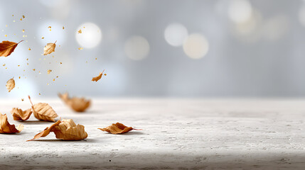 Autumn leaves gently scattered on a textured stone surface, capturing a sense of seasonal beauty and the passage of time