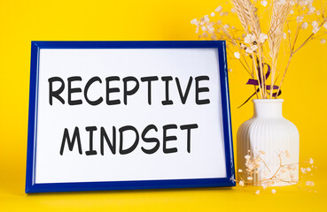 Receptive Mindset symbol. Concept words Receptive Mindset on beautiful wooden picture frame. Beautiful yellow background with flower vase. Business and Receptive Mindset concept. Copy space.