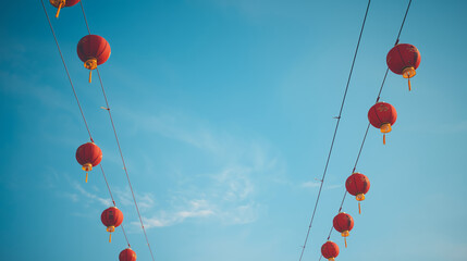 Red lanterns hanging against blue sky with large copy space for Chinese New Year