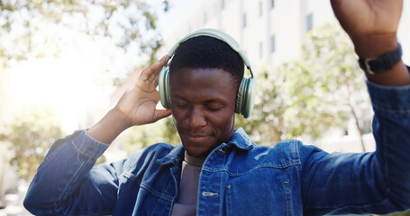 Man, student and dancing in city with headphones, favorite song or rhythm on morning commute. Black person, college academic or streaming music in town with energy, travel or positive for scholarship