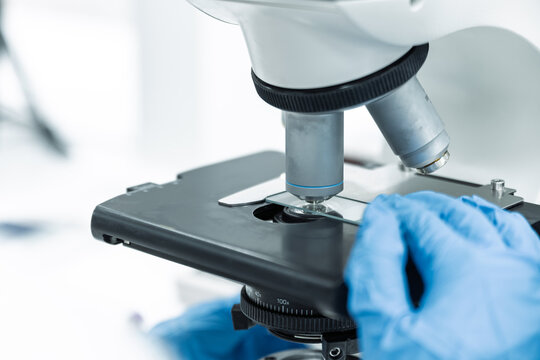 Asian women scientist looking to microscope eyepiece from CBC hematology slide in clinical laboratory.Medical technician analysis blood slide on exam plate microscopic at laboratory department.