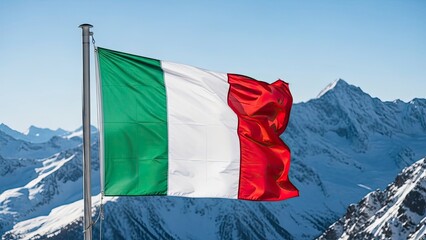 Italian flag waving in front of snow capped mountains on a clear day symbolizing national pride and travel