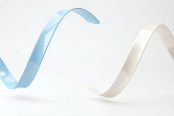 Elegant curved ribbons with golden speckles for celebration