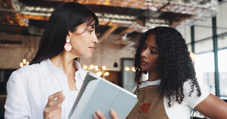 Cafe owner, waitress and meeting with tablet for online inventory checklist, staff schedule or review supplier info. Women, barista and boss on tech for menu planning, coffee shop agenda or budget