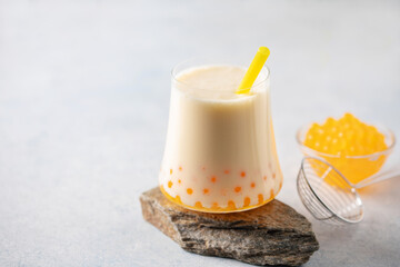 Cold iced fruit bubble tea with juice balls in glass