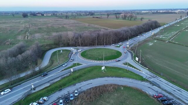 Aerial view of a busy roundabout intersection on a cloudy day in Italy