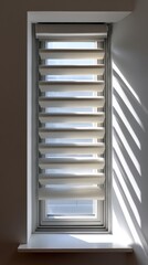 Top view of a modern window with sleek horizontal blinds and direct sunlight creating bold shapes 
