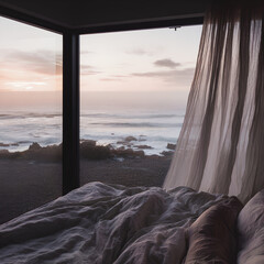 Unmade bed in a modern room overlooking a serene ocean at dawn